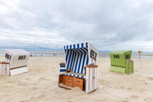 a group of beach chairs sitting on the beach at Nordseehotel Kröger in Langeoog