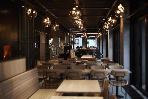 a row of tables and chairs in a restaurant at Steel House Copenhagen in Copenhagen