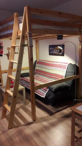 a bunk bed with a ladder in a room at studio saint lary soulan in Saint-Lary-Soulan