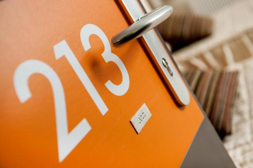 a close up of an orange cell phone at Hotel Florence in Lourdes