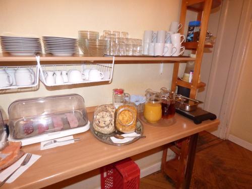 a table with a plate of food and glasses of orange juice at Hotel Pension Bernstein am Kurfürstendamm in Berlin