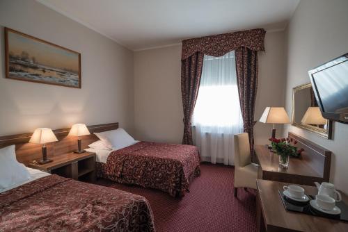 Jasek Premium Hotel Wrocławにあるベッド