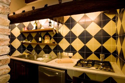 a kitchen with a sink and a stove in it at Casa Margaret in Collesano