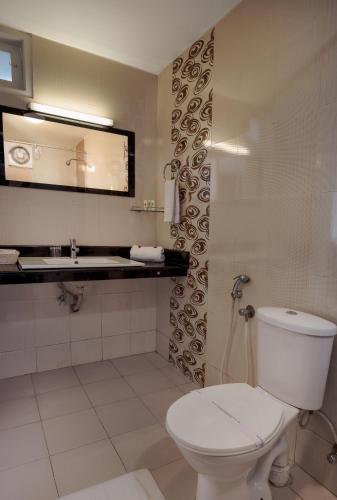 a bathroom with a toilet and a sink at Munnar Tea Hills Resort - MTHR in Munnar