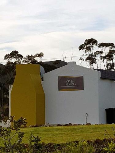 a building with a sign on the side of it at Windfall Wine Farm in Robertson