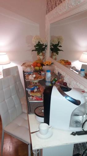 a room with a table and a counter with food at Barberini Dream in Rome