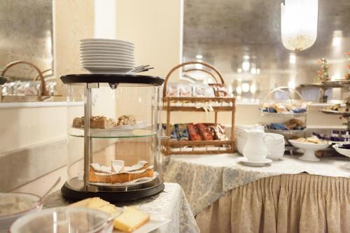a table with a plate of bread and other food at Hotel San Luca in Verona