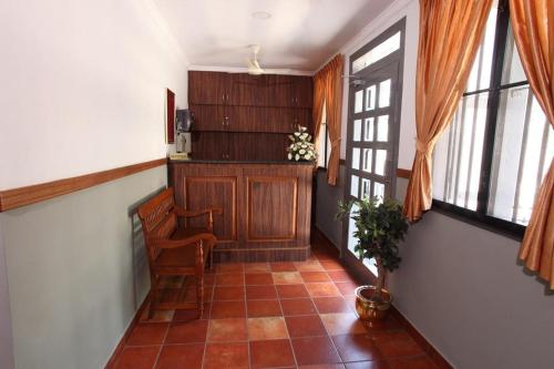 a hallway with a bench in a room with windows at The Boat Jetty Bungalow in Cochin