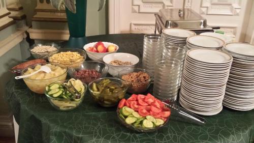 a table topped with plates and bowls of food at Tisza Hotel in Szeged