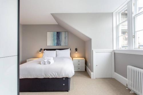 a bedroom with a bed with two towels on it at ALTIDO Spacious 2BR Apt, moments from West End in Edinburgh