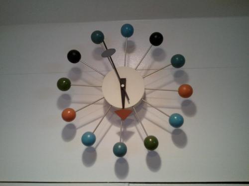 a clock with balls on a wall at Agave Inn in Santa Barbara