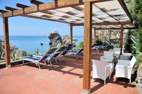 a patio with chairs and a view of the ocean at Grand Hotel San Michele in Cetraro
