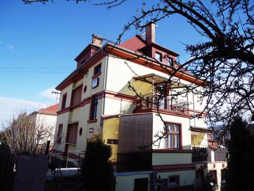 a large white house with a red roof at Pension Lada in Karlovy Vary