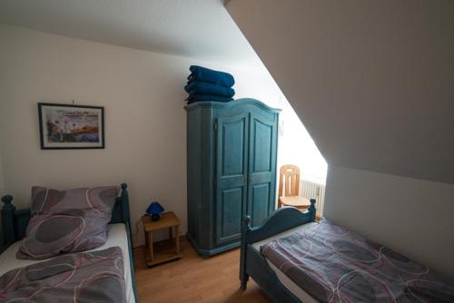 ジンメラートにあるRursee-Panoramaのベッドルーム1室(ベッド2台、青いキャビネット付)