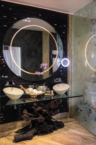 a bathroom with two sinks and a mirror at Makanda by The Sea Hotel Adults Only in Manuel Antonio