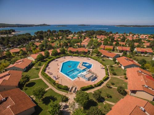 an aerial view of a house with a swimming pool at Victoria Mobilehome BI VILLAGE in Fažana