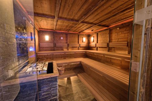 an empty sauna with wooden walls and wooden ceilings at Das Naturjuwel in Fiss