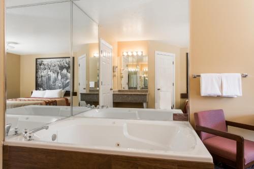 a large bathroom with a tub and a bedroom at Hotel Zion Inn, Zion National Park Area in Hurricane