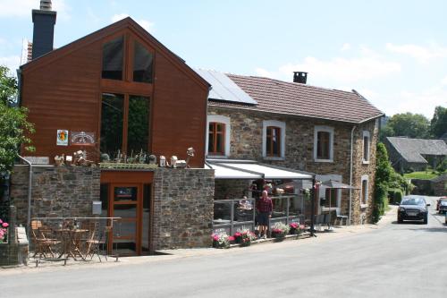 a building with a restaurant on the side of a street at Les Chanterelles in Jalhay