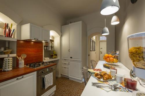 a kitchen with a table with a bowl of fruit on it at Moscova Luxury B&B in Milan