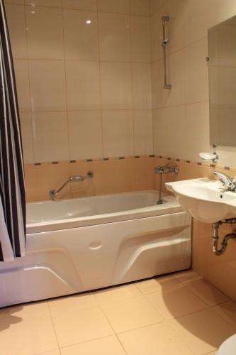 バンスコにあるFortuna Luxury Apartmentのバスタブと洗面台のあるバスルーム