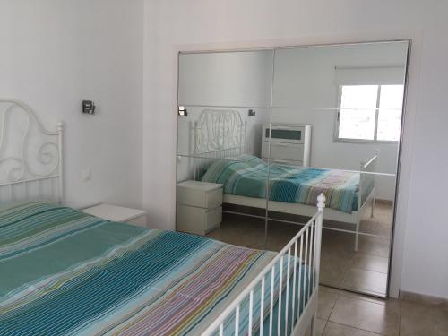 a bedroom with two beds and a large mirror at Paraiso 12 - 1bedroom in Playa Paraiso