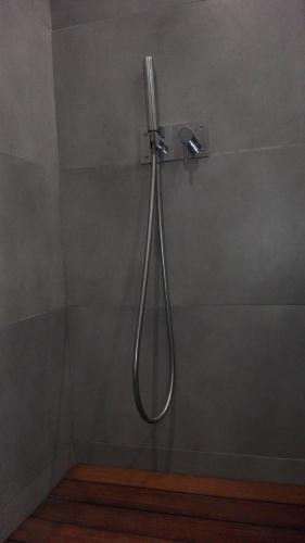 a shower in a bathroom with a shower head at Shearwaters - Sounds of the sea in Funchal