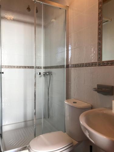 a bathroom with a shower and a toilet and a sink at Alojamiento Rural La Mejora in Conil de la Frontera
