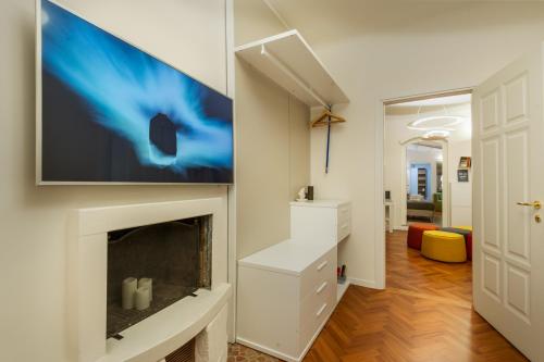 a living room with a fireplace and a flat screen tv at Moscova Luxury B&B in Milan