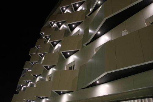 a facade of a building with lights on it at Aurea Fatima Hotel Congress & Spa in Fátima