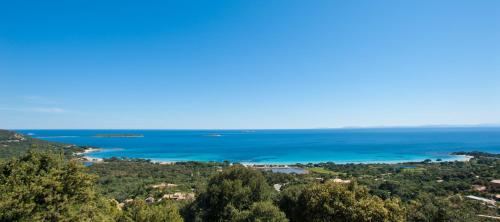 a view of the ocean from the top of a hill at Résidence Belvedere de Palombaggia in Porto-Vecchio