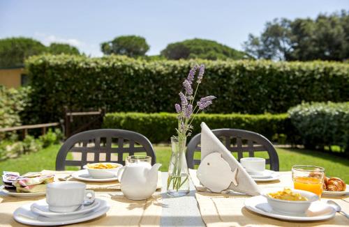 a table with plates of food and drinks on it at Camping Village Baia Azzurra in Castiglione della Pescaia