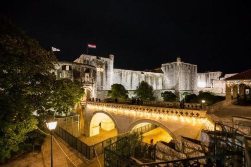 a castle at night with a bridge in front at Apartment Anet with free parking in Dubrovnik