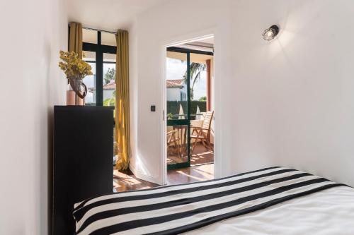 a bedroom with a bed and a view of a patio at Varandas do Funchal I by An Island Apart in Funchal