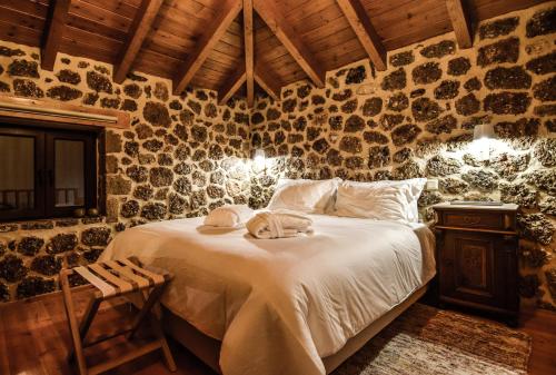 a bedroom with a bed with towels on it at Anotopos in Ano Trikala