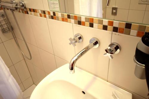 a bathroom with a toilet and a sink at Waldhotel Schinkenwirt in Olsberg