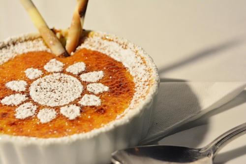 a bowl of food on a table with a spoon at Locanda Gli Ulivi in Monteveglio