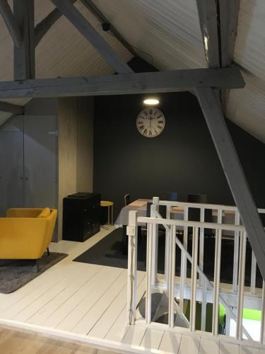 a room with a bed and a clock on a wall at The Cottage and The Loft in Amblève