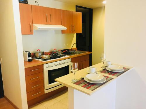 una cocina con barra y 2 copas de vino en Apartment Down Town 422, en Ciudad de México