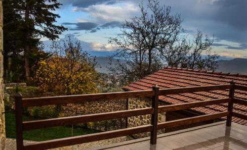 a wooden bench sitting on top of a balcony at Anotopos in Ano Trikala
