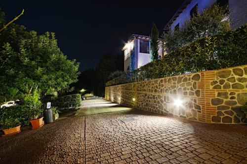 a brick wall with a light on it at night at Locanda Gli Ulivi in Monteveglio