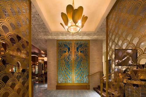 a lobby with a large door with a chandelier at Hotel Bijou - Union Square in San Francisco