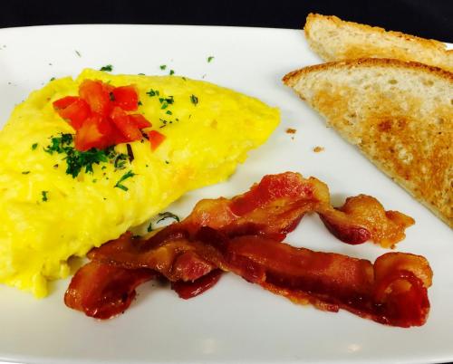 a plate of breakfast food with eggs bacon and toast at Afton House Inn in Afton