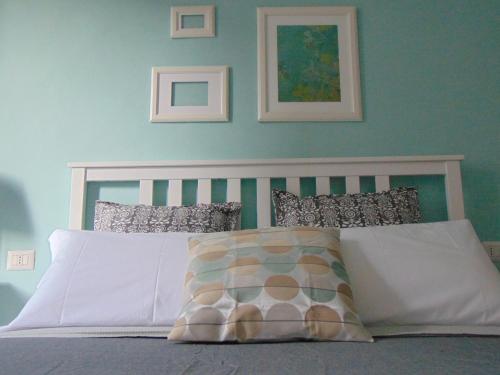 a bedroom with a white bed with blue walls at Lost In Florence in Florence