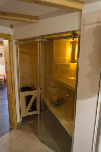 a walk in closet in a room with wood at Ferienwohnung Lämpelberg in Klingenthal