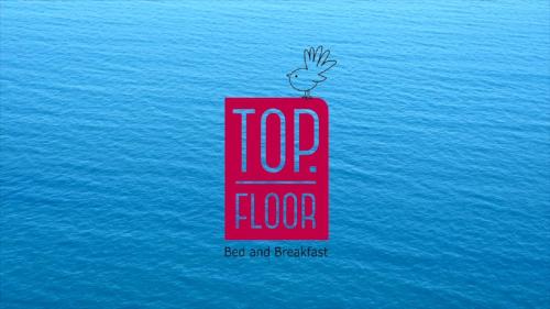 a bird sitting on top of a block in the water at Top Floor Bed and Breakfast in Paraparaumu Beach