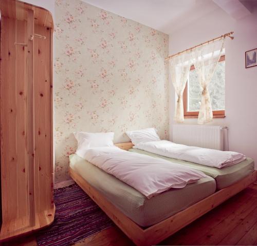 a bedroom with a bed and a window at Pension Cabana Cetatile Ponorului in Padis