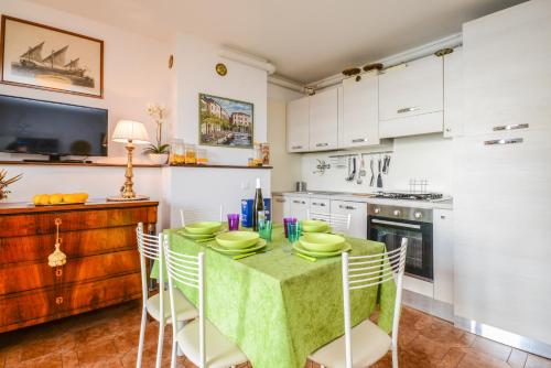 a kitchen with a table with a green table cloth at Ex dimora di Lawrence in Gargnano