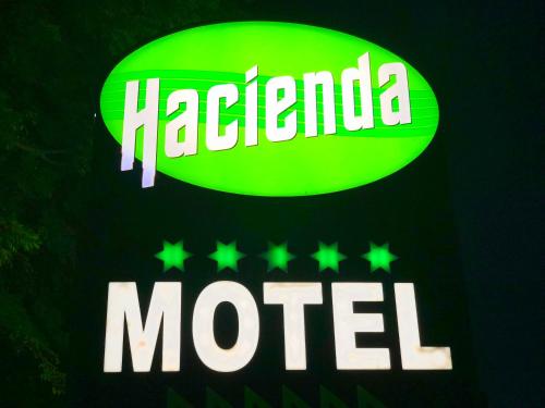 a neon sign for a mocha motel at Hacienda Motor Lodge in Palmerston North