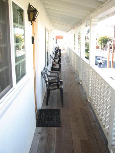 a row of chairs sitting on a porch at Oceana Boutique Hotel in San Clemente